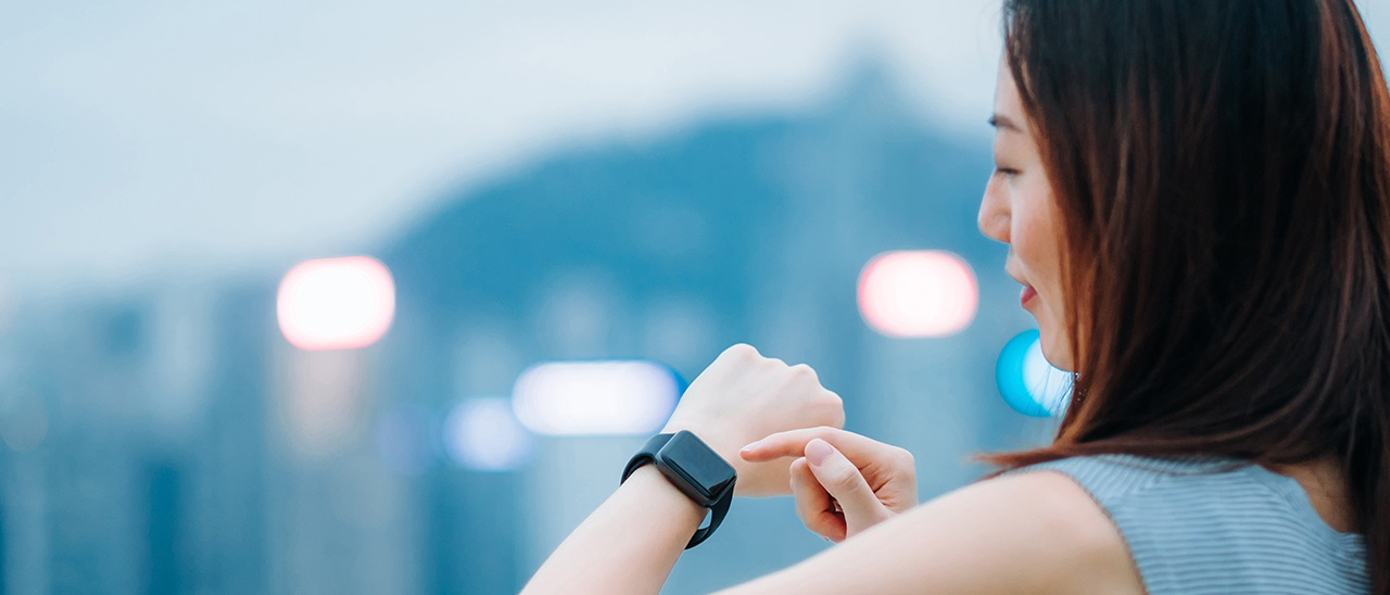 woman adjusting smartwatch